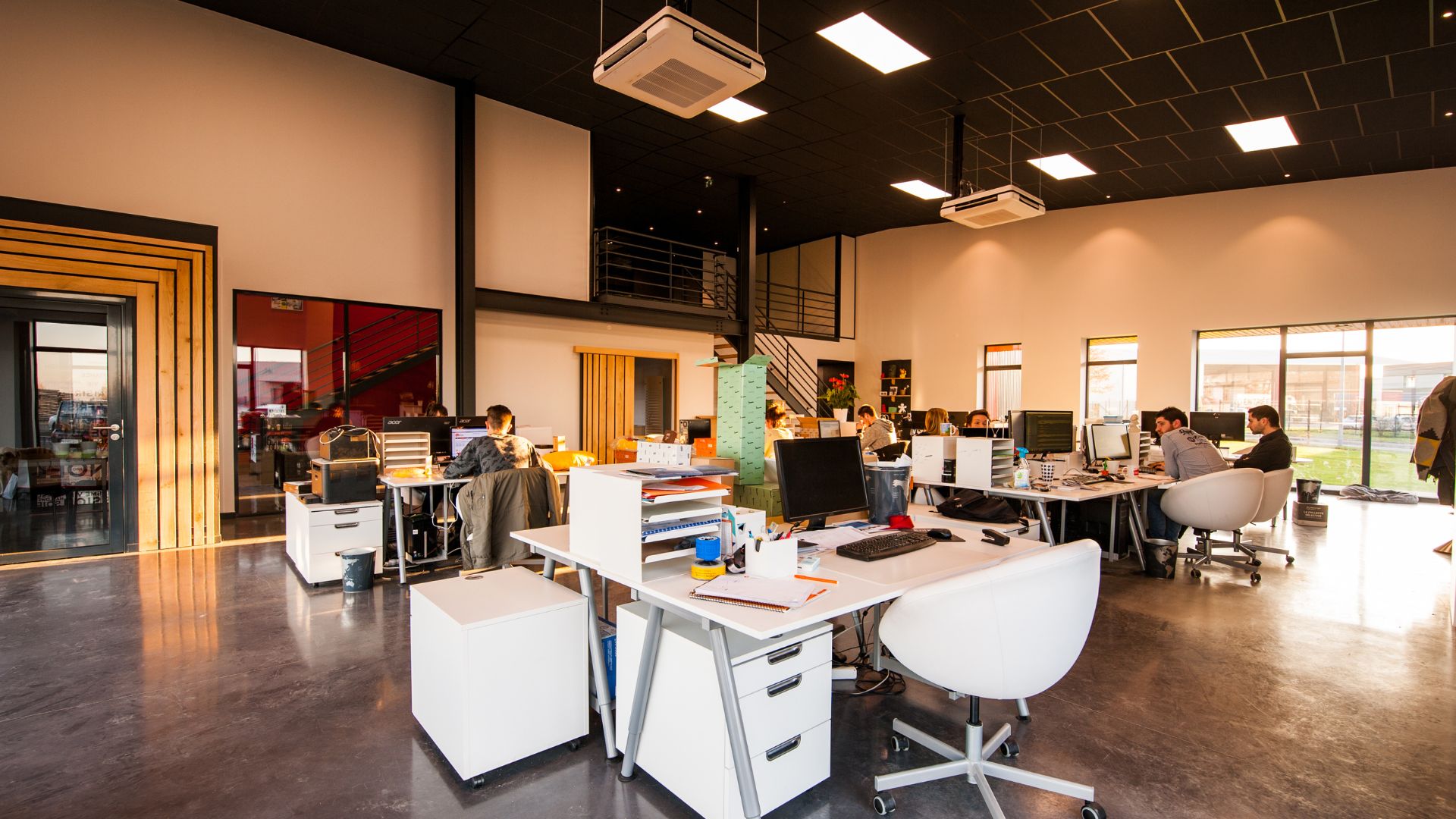 A group of people sitting at desks in an office