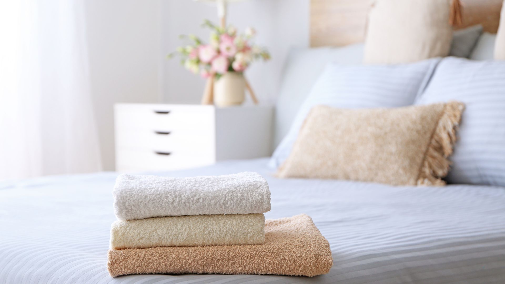 Towels folded on a bed in a bedroom