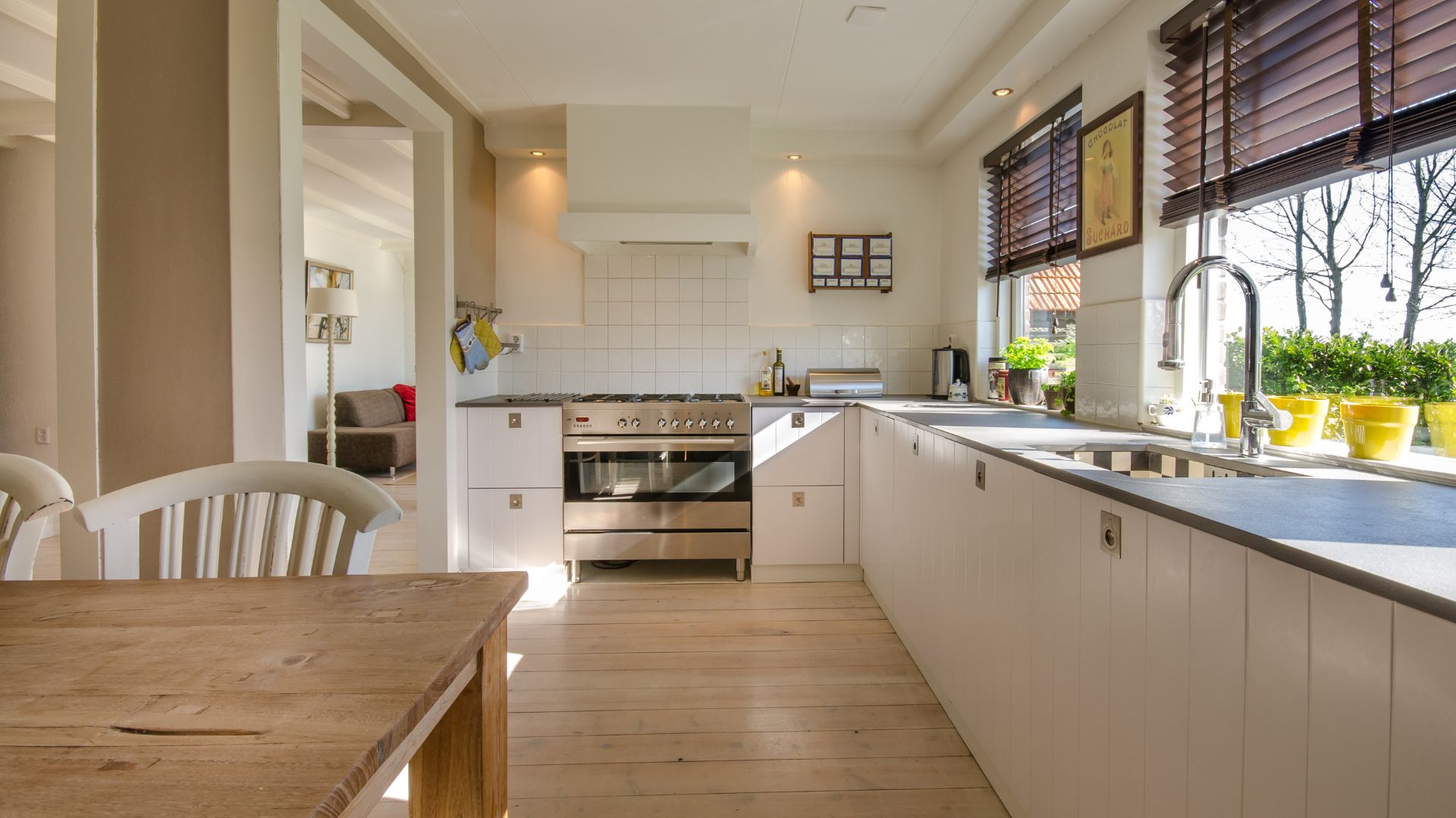 A kitchen with a wooden table and white cabinets